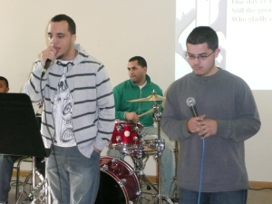 Eddie Jenkins Jr. (left) ministers during worship at a youth retreat.